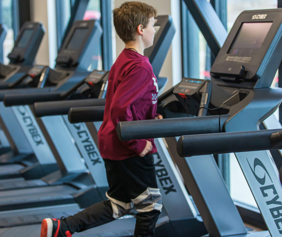 Photo of a teenage male running on a treadmill