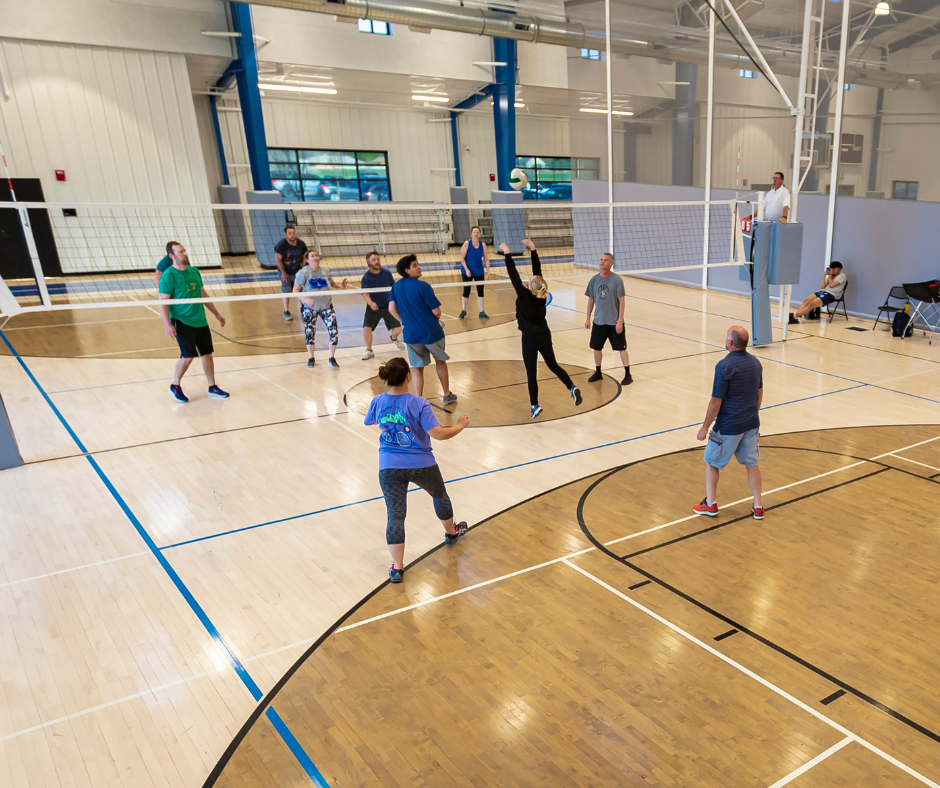 Photo of an adult coed volleyball game